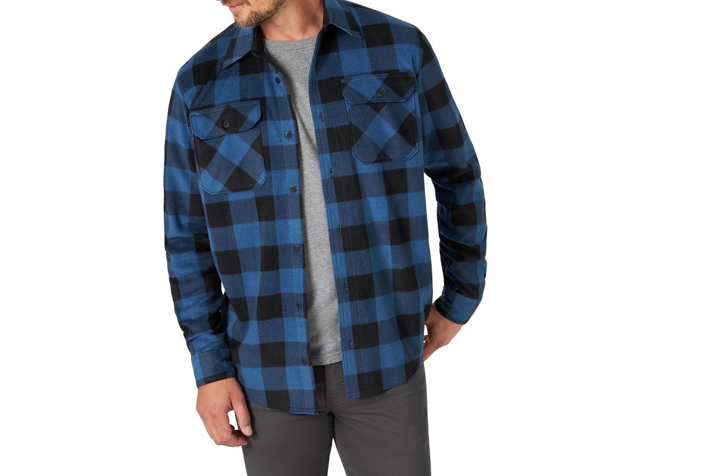 A man wearing a blue and black flannel shirt