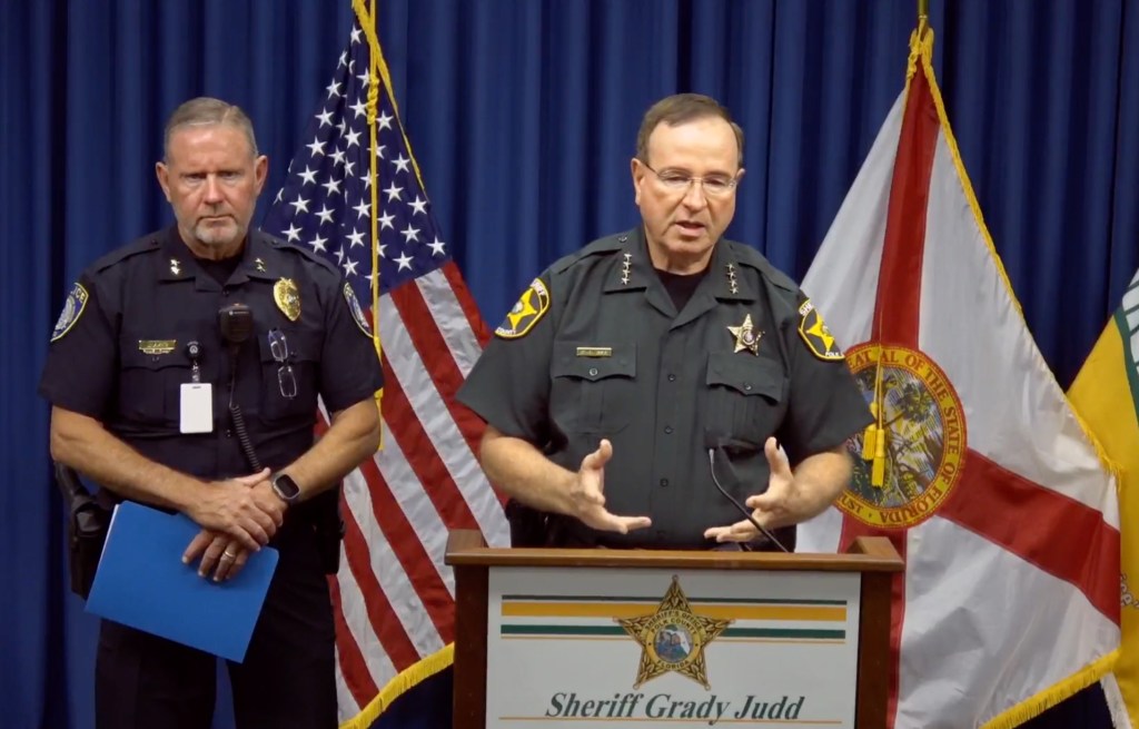 Polk County Sheriff Grady Judd speaks at a podium.