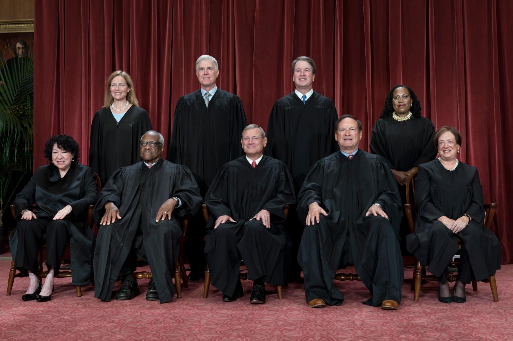 Group portrait of Supreme Court Justices, including newly added Associate Justice Ketanji Brown Jackson, sitting in the Supreme Court building in Washington.