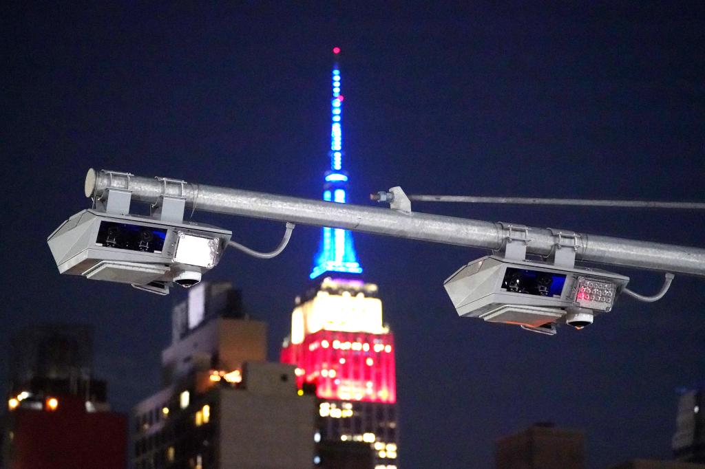 A general view of a congestion pricing toll gantry with the Empire State Building behind it as seen on W40th Street in New York, NY on May 22, 2024.