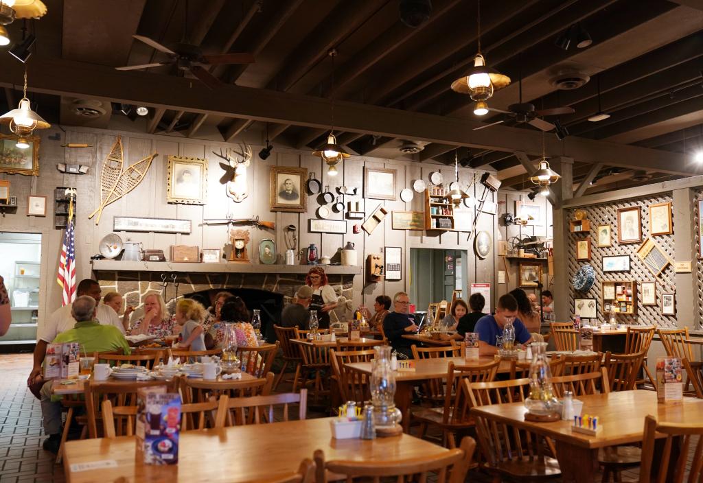 Group of people sitting at tables inside a Cracker Barrel restaurant in Mount Arlington, NJ, featuring new booths and banquettes.