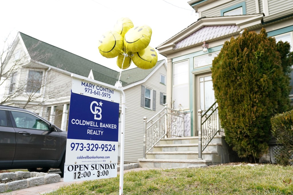 For sale sign in front of home