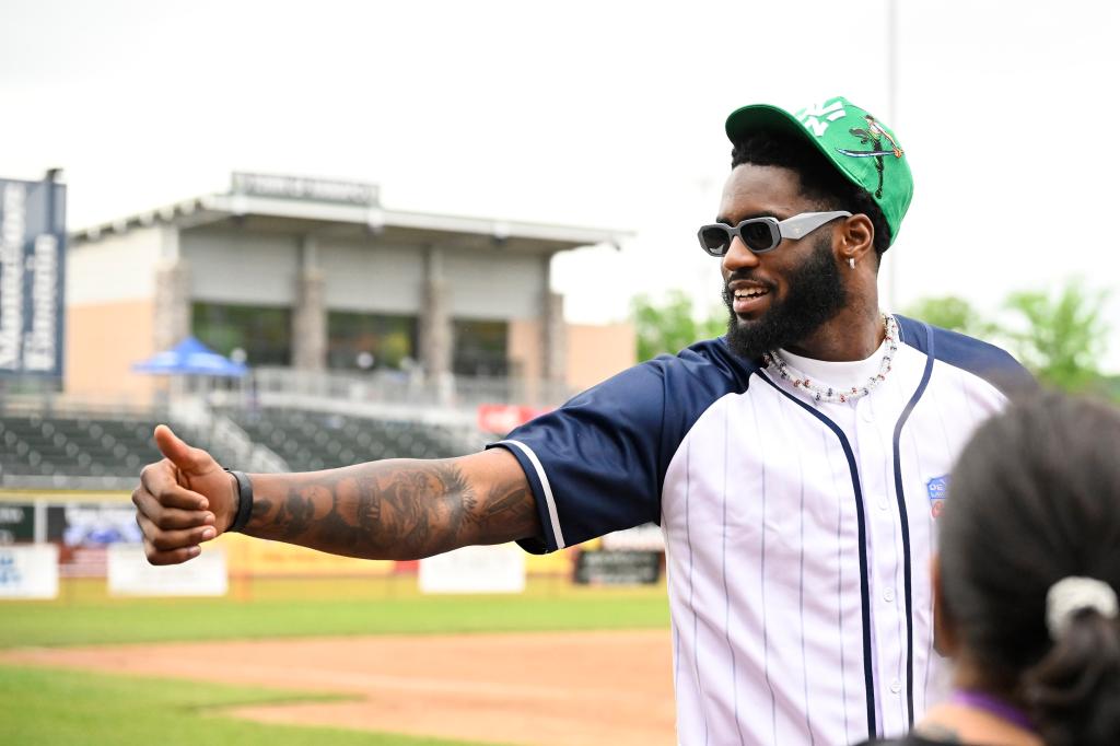 Giants' Brian Burns acknowledges the fans before the Dexter Lawrence celebrity softball game at Clover Stadium in Pomona, NY.