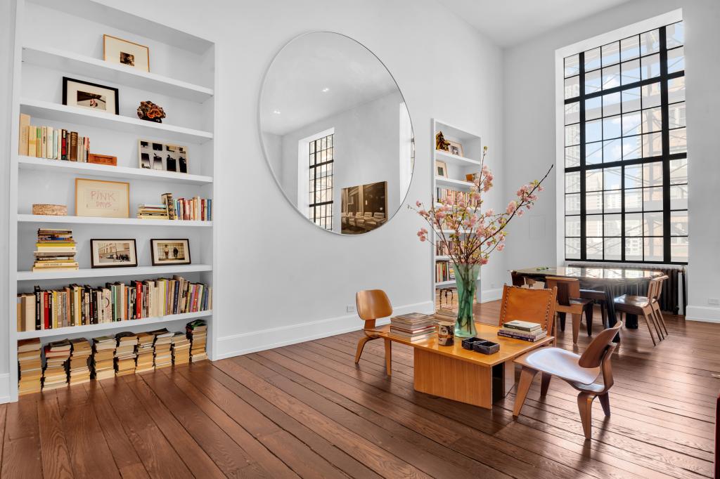 Design details include vintage restored wide plank hardwood floors and circular infinity mirrors. 