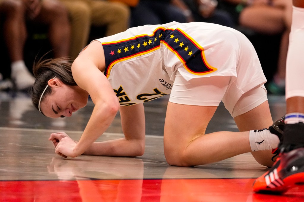 Indiana Fever guard Caitlin Clark (22) grimaces after being injured in the first half of a WNBA basketball game against the Connecticut Sun in Indianapolis, Monday, May 20, 2024.  