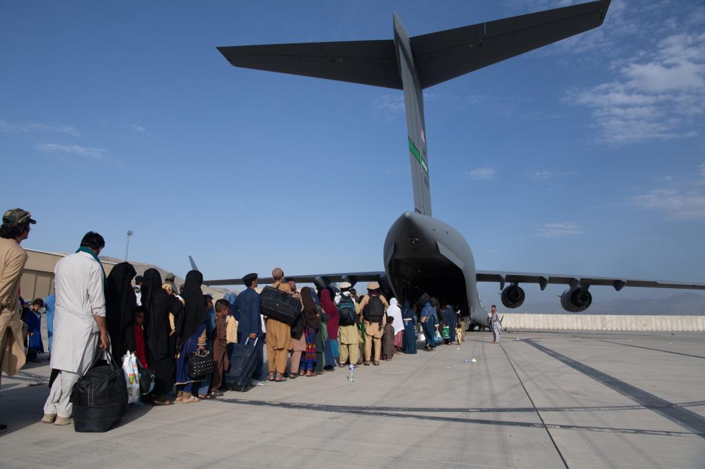 In this handout provided by U.S. Central Command Public Affairs, U.S. Air Force loadmasters and pilots assigned to the 816th Expeditionary Airlift Squadron, load passengers aboard a U.S. Air Force C-17 Globemaster III in support of the Afghanistan evacuation at Hamid Karzai International Airport (HKIA) on August 24, 2021 in Kabul, Afghanistan.