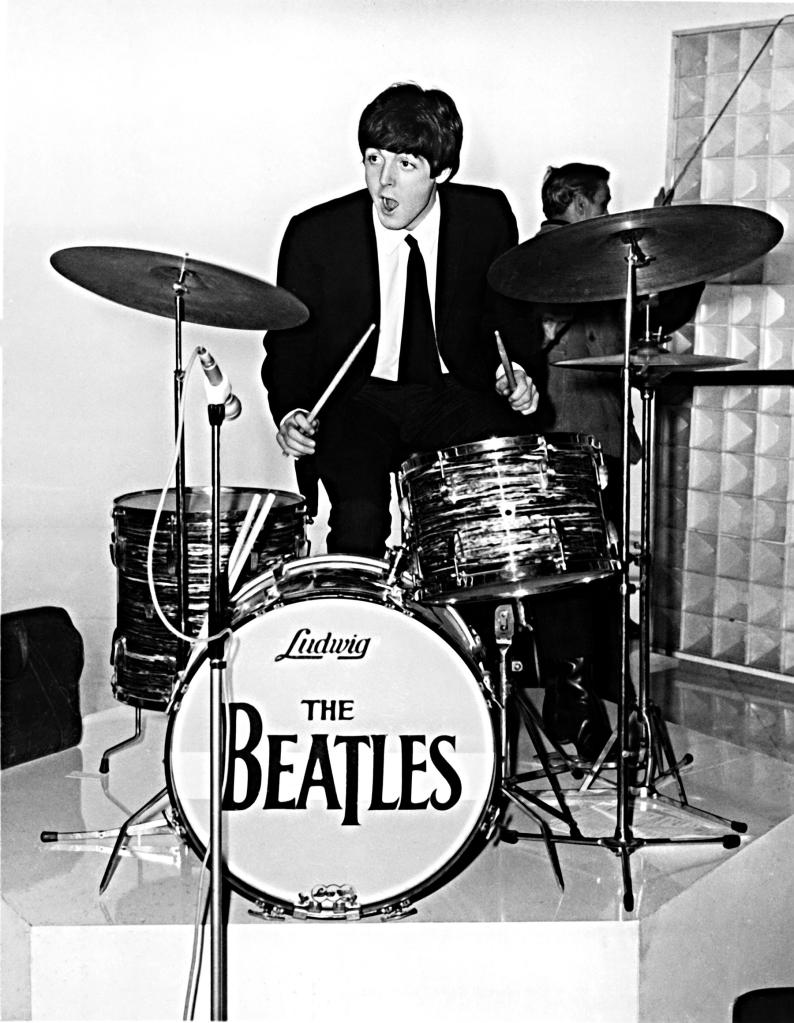 Paul McCartney, from The Quarrymen, playing Ringo Starr's drums on a break during the filming of A Hard Day's Night in 1964