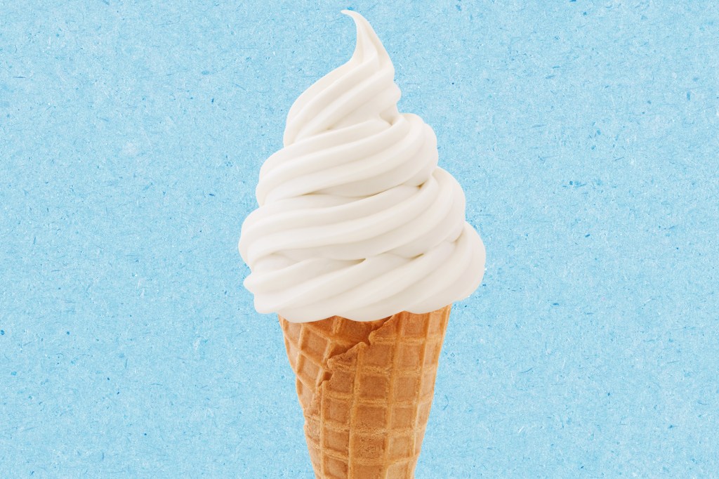 Soft serve ice cream cone on a blue textured paper background