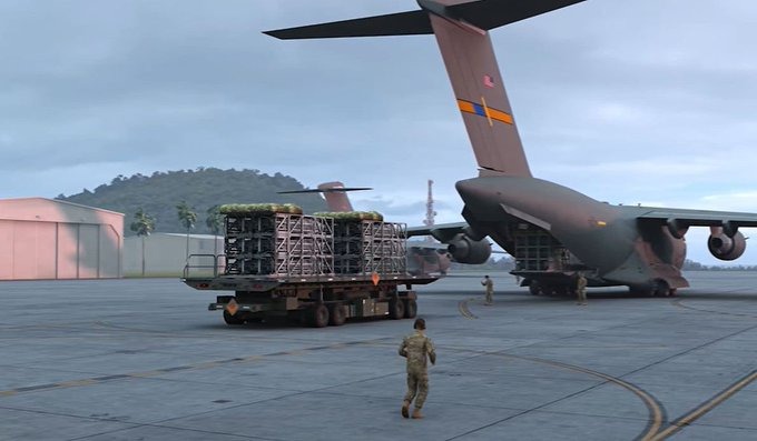 A large military cargo plane on a tarmac.