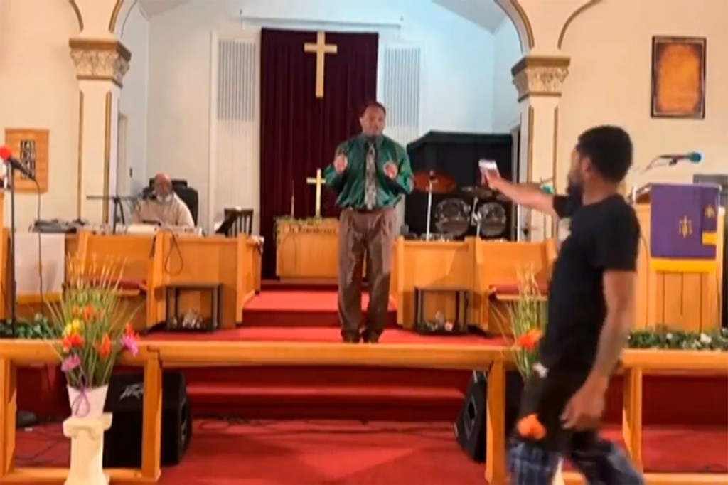 Pastor Glenn Germany, center, at the Jesus Dwelling Place church in North Braddock, Pa