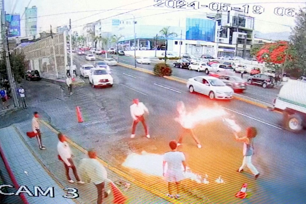 The flame-swallower tossed fire balls at the mariachi band in the middle of street.