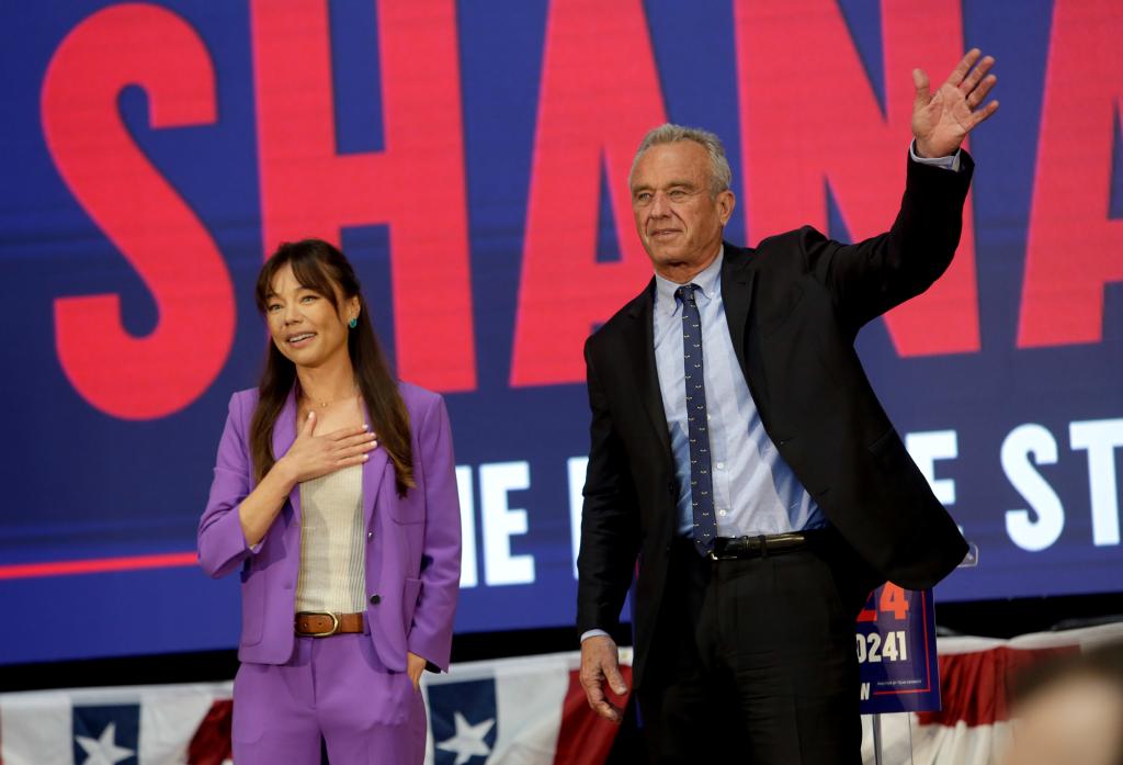 Robert F. Kennedy Jr. (R) and his vice presidential pick Nicole Shanahan wave during a campaign event to announce his pick for running mate on March 26, 2024 in Oakland, California.