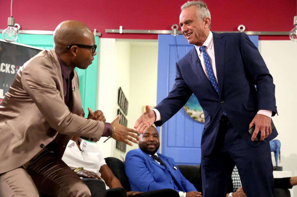 Robert F. Kennedy, Jr., right, greets fellow panelist Eddie Long, Jr., radio personality, songwriter and author at the start of, "The Present State of Black America."