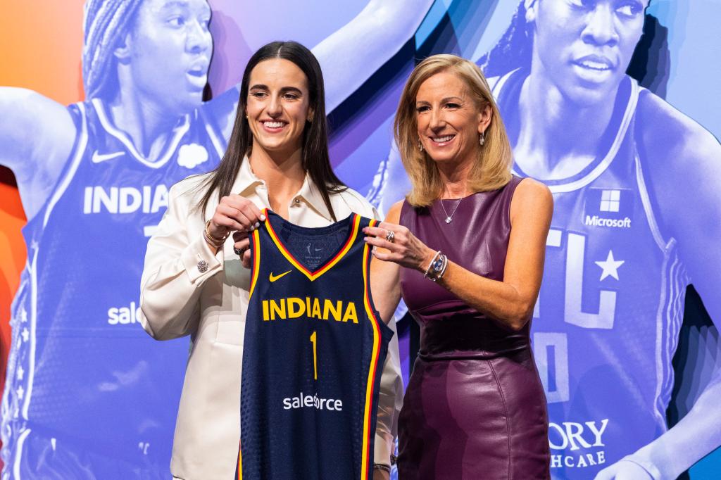 Caitlin Clark stands with the WNBA commissioner Cathy Engelbert on draft night.