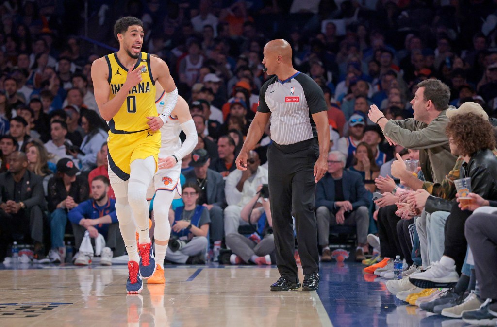 Indiana Pacers guard Tyrese Haliburton #0 and a fan court side exchange words during the second quarter of Game 7 on Sunday.