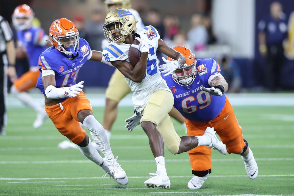 UCLA Bruins defensive back Alex Johnson (36) runs an interception back for few yards during the Starco Brands LA Bowl between the UCLA Bruins and the Boise State Broncos on December 16, 2023, at SoFi Stadium in Inglewood, CA.