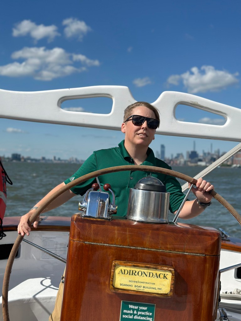 Captain Cait Field, a woman in sunglasses, on a boat on June 10, 2024