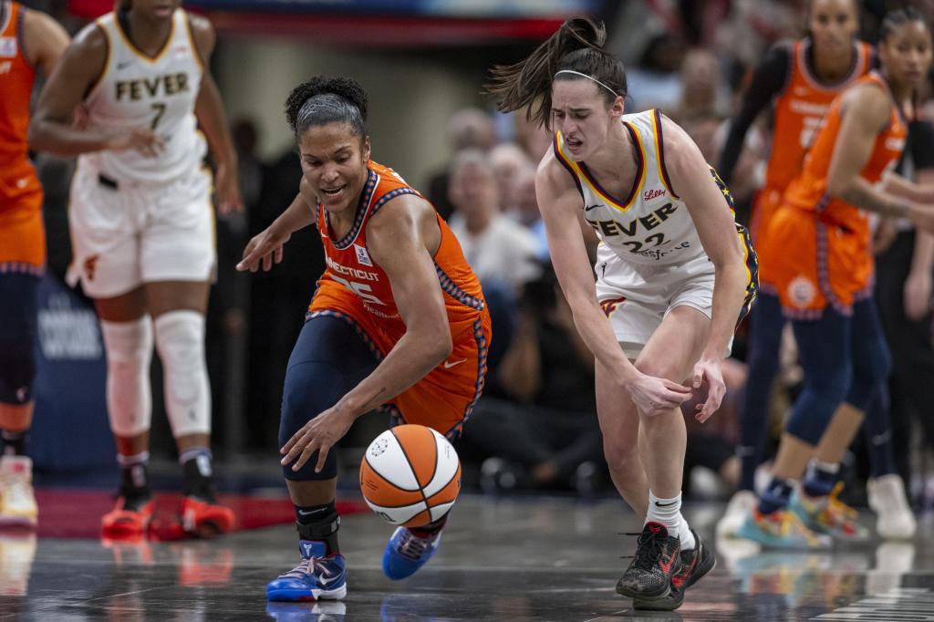 Connecticut Sun forward Alyssa Thomas (25) knocks the ball away from Indiana Fever guard Caitlin Clark (22) during the second half of an WNBA basketball game, Monday, May 20, 2024, at Gainbridge Fieldhouse.