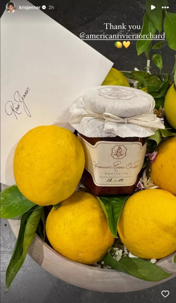 Kris Jenner showcasing a jar of strawberry jam from Meghan Markle's American Riviera Orchard placed on lemons