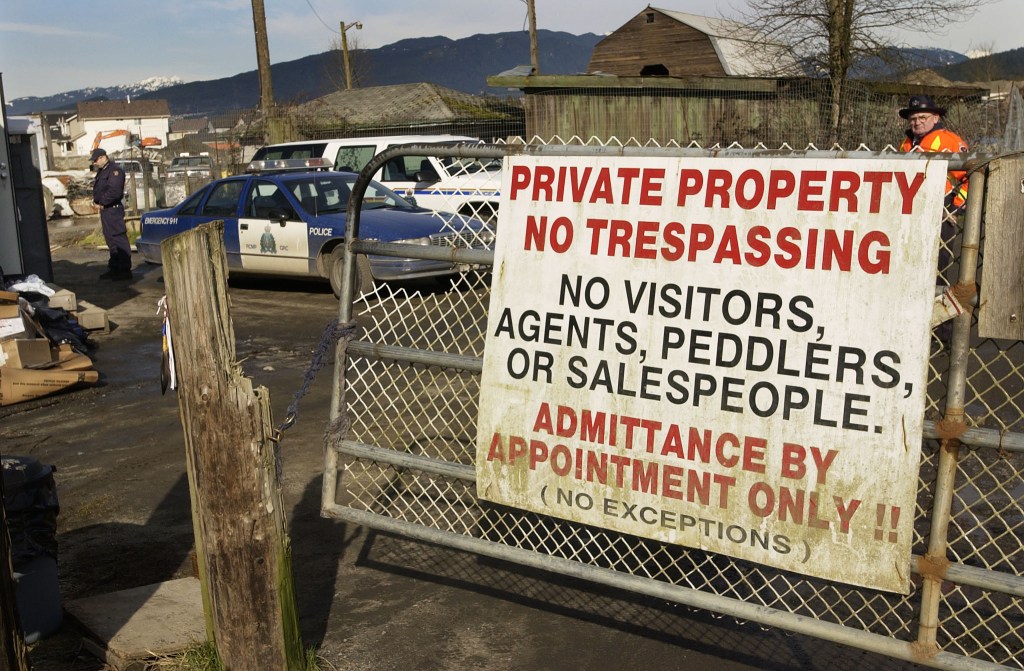 The entrance to the pig farm with a no trespassing sign.