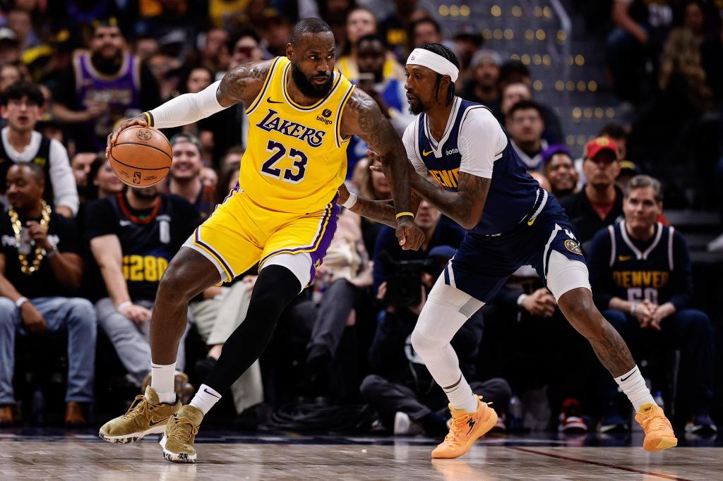 Lakers forward LeBron James (23) controls the ball as Denver Nuggets guard Kentavious Caldwell-Pope (5) guards in the third quarter during game five of the first round for the 2024 NBA playoffs at Ball Arena.  