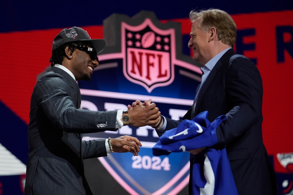 LSU wide receiver Malik Nabers celebrates with NFL Commissioner Roger Goodell