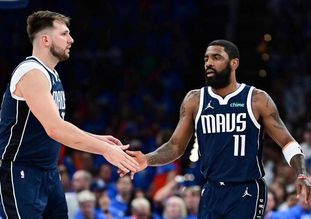 Luka Doncic #77 high fives Kyrie Irving #11 of the Dallas Mavericks during the third quarter against the Oklahoma City Thunder in Game One of the Western Conference Second Round Playoffs at Paycom Center on May 07, 2024 in Oklahoma City, Oklahoma.