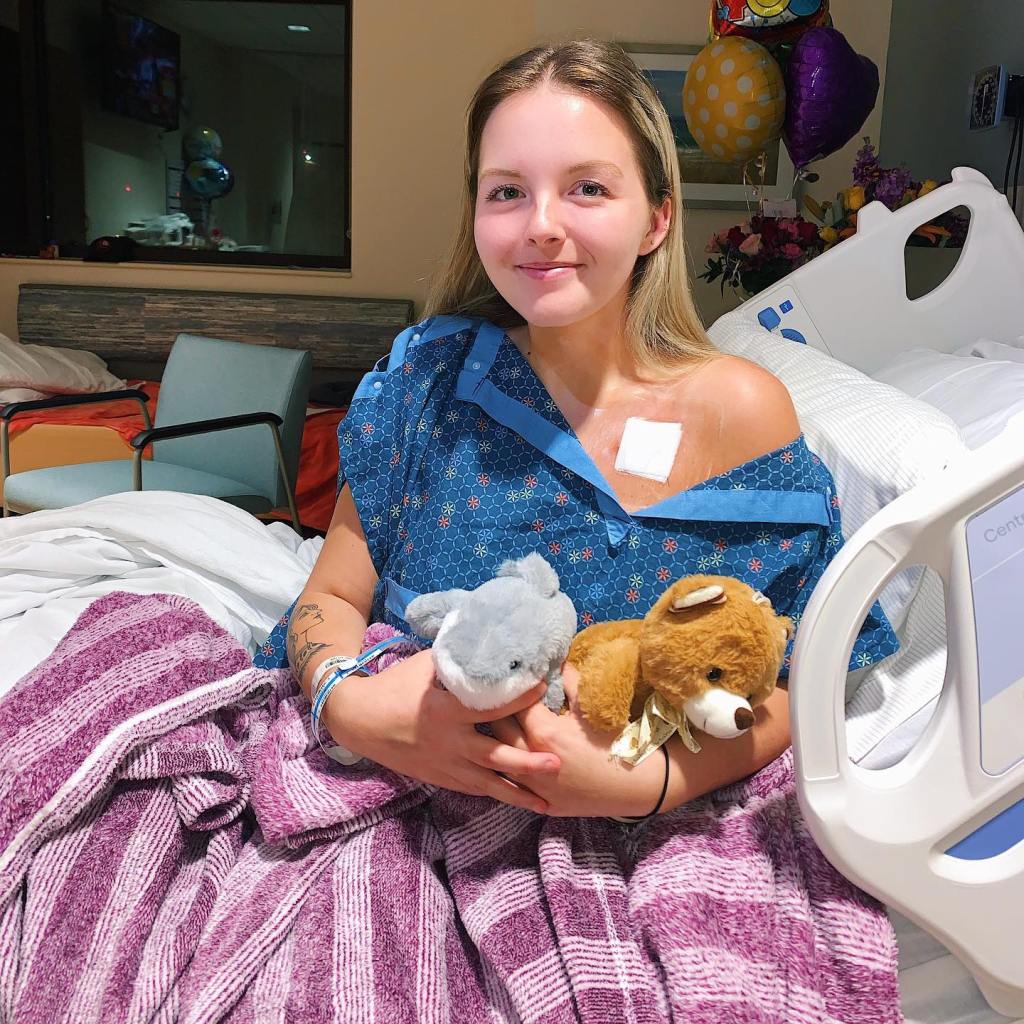 Maddy Baloy, a TikTok sensation, in a hospital bed holding stuffed animals, who shared her terminal cancer journey with millions