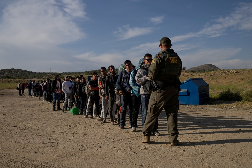 Migrants lining up to be processed by Border Patrol