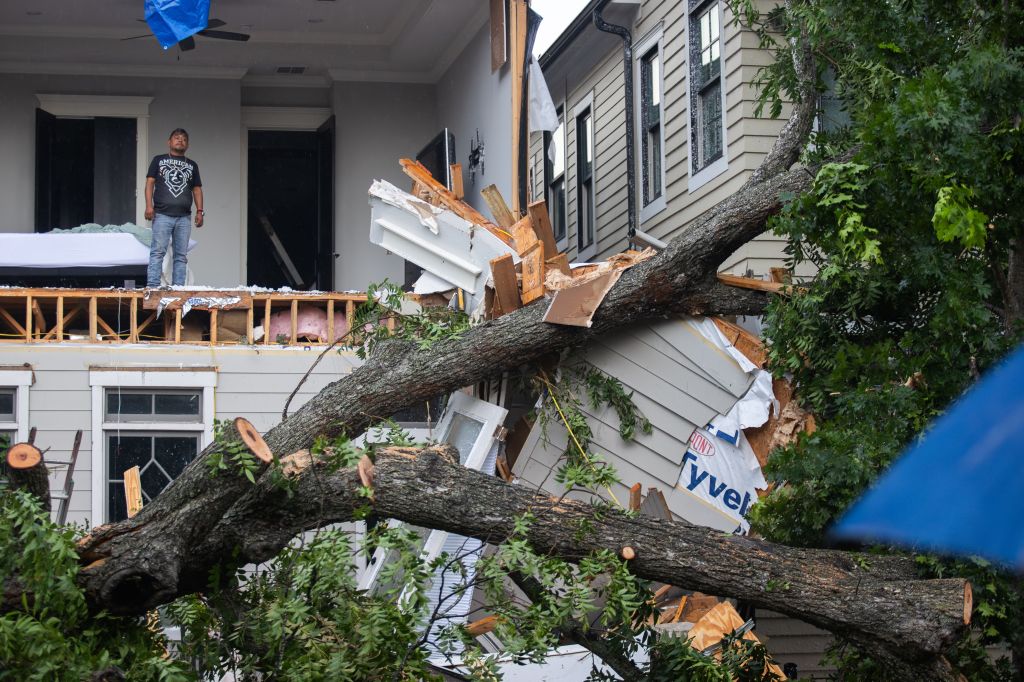 A man is looking out from inside a destroyed home in the Houston Heights at Ashland St. and 27th St. in Houston, United States, on May 17, 2024.