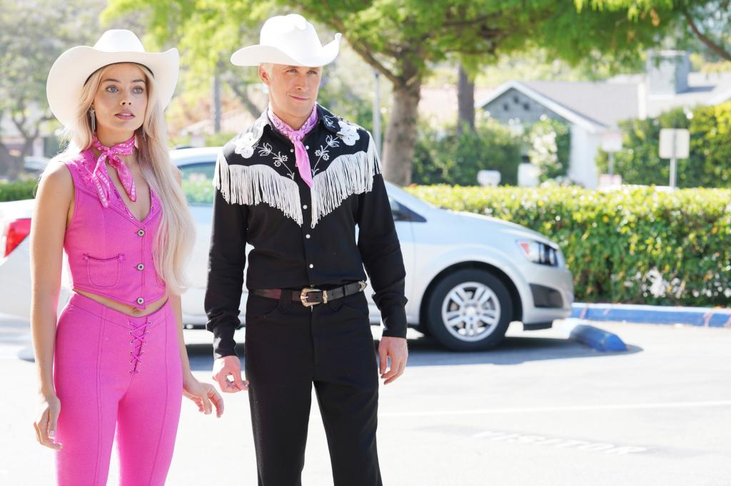 Margot Robbie and Ryan Gosling dressed in cowboy clothing for the movie BARBIE, 2023