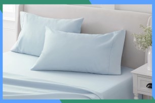 A bed with a white sheet and pillow