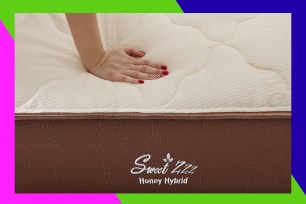 A hand resting on a mattress