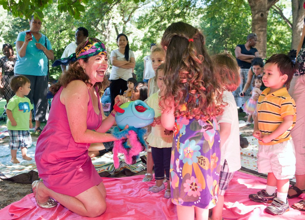 Melissa Levis, founder of Moey's Music Party, rocks out with youngsters in Central Park