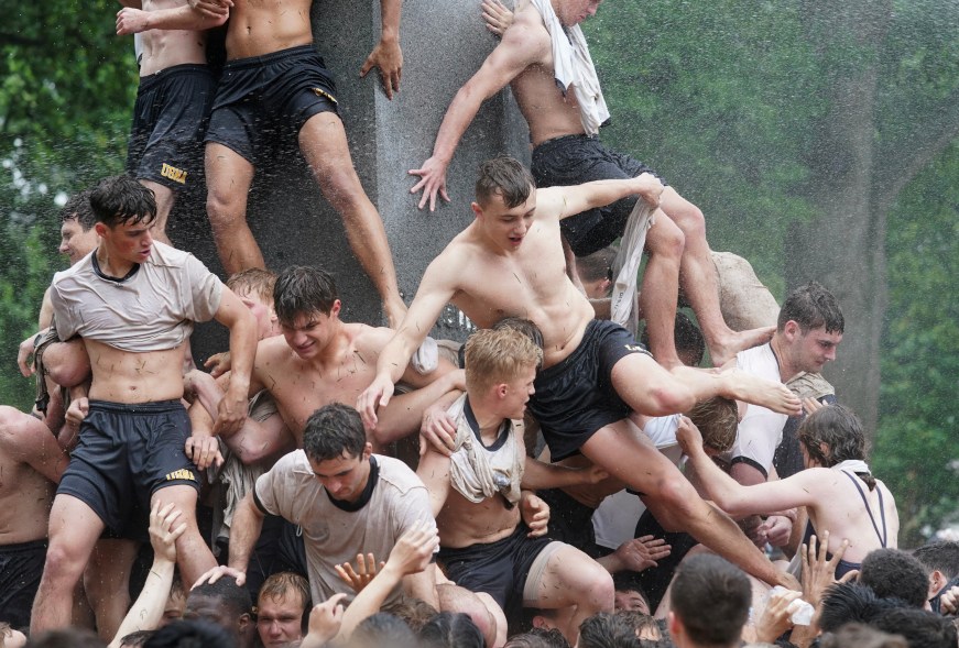 Plebes climb the Herndon Monument at the U.S. Naval Academy, Wednesday, May 15, 2024, in Annapolis, Maryland.