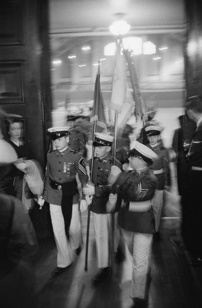 Members of the Knickerbocker Greys Youth Corps, attached to the 7th Regiment, participating in afterschool activities in the Knickerbocker Greys program, at Park Avenue Armory, New York City, 1957. 