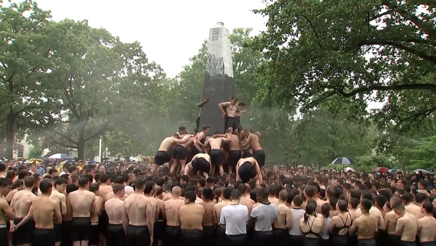 Plebes climb the Herndon Monument at the U.S. Naval Academy, Wednesday, May 15, 2024, in Annapolis, Maryland.