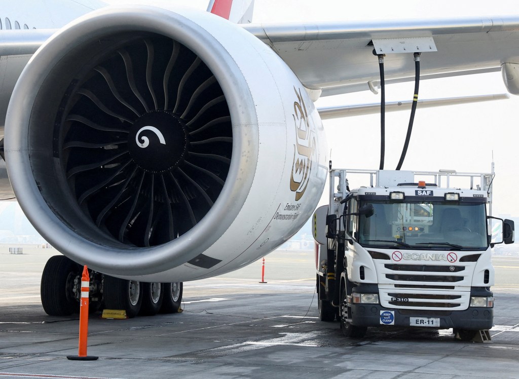 A fuel truck fills up the Emirates Airlines Boeing 777-300ER with Sustainable Aviation Fuel (SAF), 