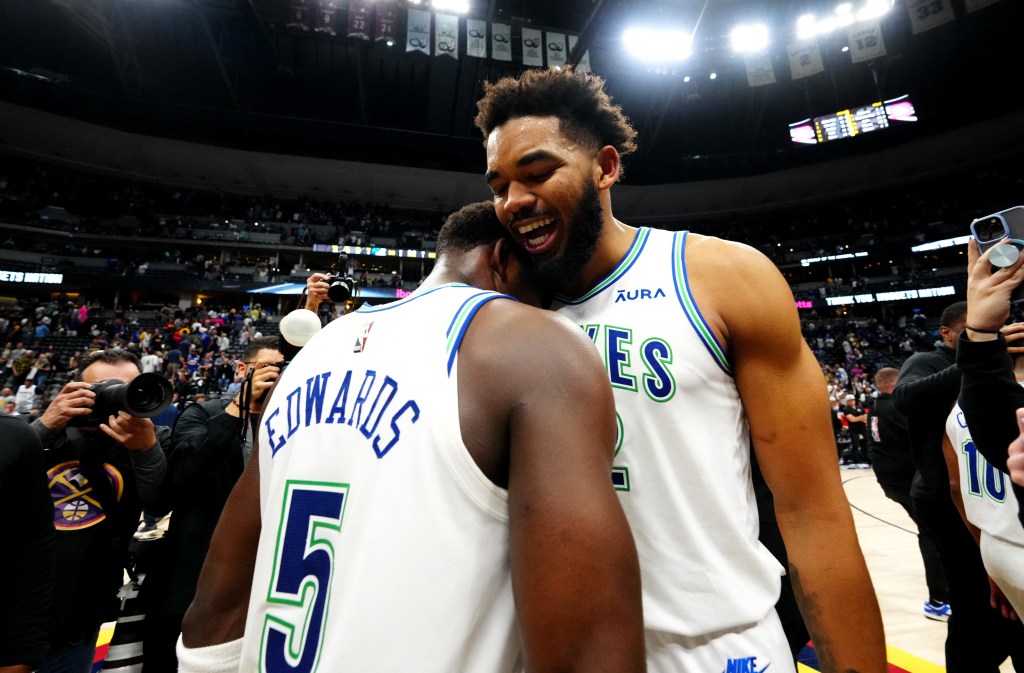 Karl-Anthony Towns (32) and Anthony Edwards (5) celebrate defeating the Denver Nuggets in game seven of the second round for the 2024 NBA playoffs at Ball Arena. 