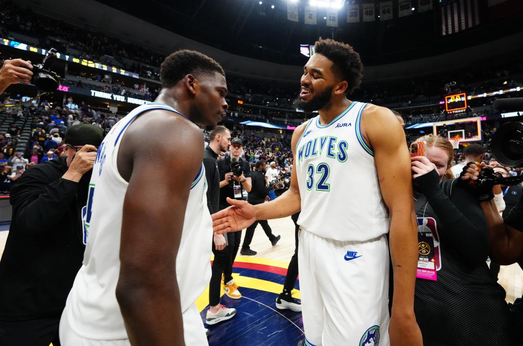 Timberwolves guard Anthony Edwards (5) and center Karl-Anthony Towns (32) celebrate defeating the Denver Nuggets in Game 7 of the second round of the 2024 NBA playoffs at Ball Arena on May 19, 2024. 