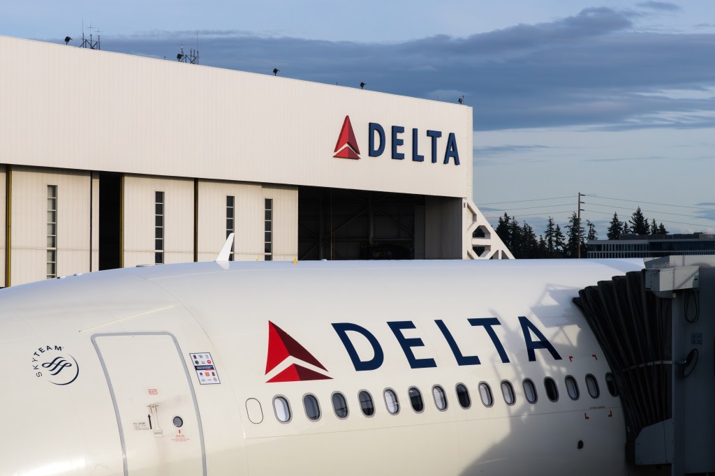 Delta Air Lines plane and aircraft hanger at SeaTac, WA, USA on April 26, 2023
