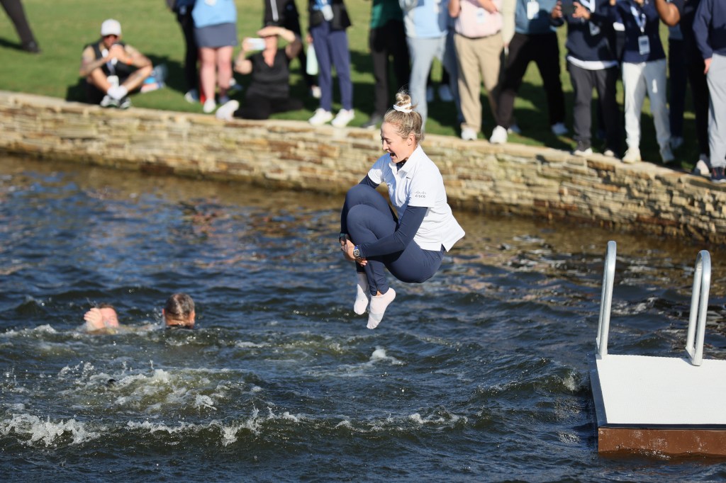 Nelly Korda of the United States jumps into the water after winning The Chevron Championship at The Club at Carlton Woods on April 21, 2024 in The Woodlands, Texas. 