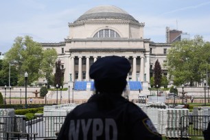 New York City police officer overseeing the usually bustling center of Columbia University, devoid of the usual graduation ceremony due to recent pro-Palestinian protests