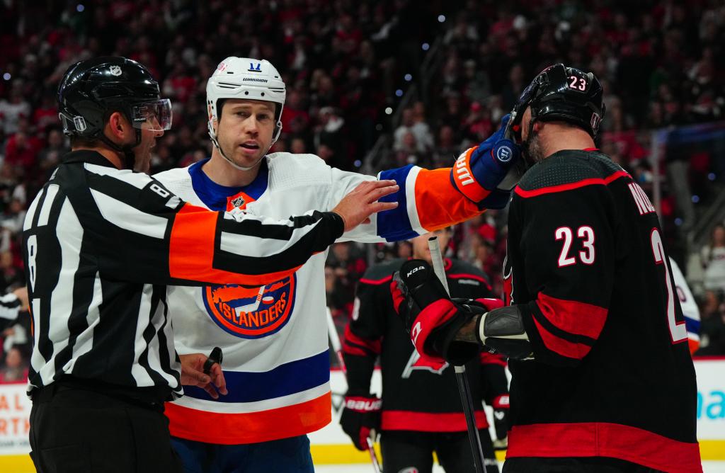 New York Islanders left wing Matt Martin (17) grabs hold of Carolina Hurricanes right wing Stefan Noesen (23) face shield during the third period in game two of the first round of the 2024 Stanley Cup Playoffs at PNC Arena.