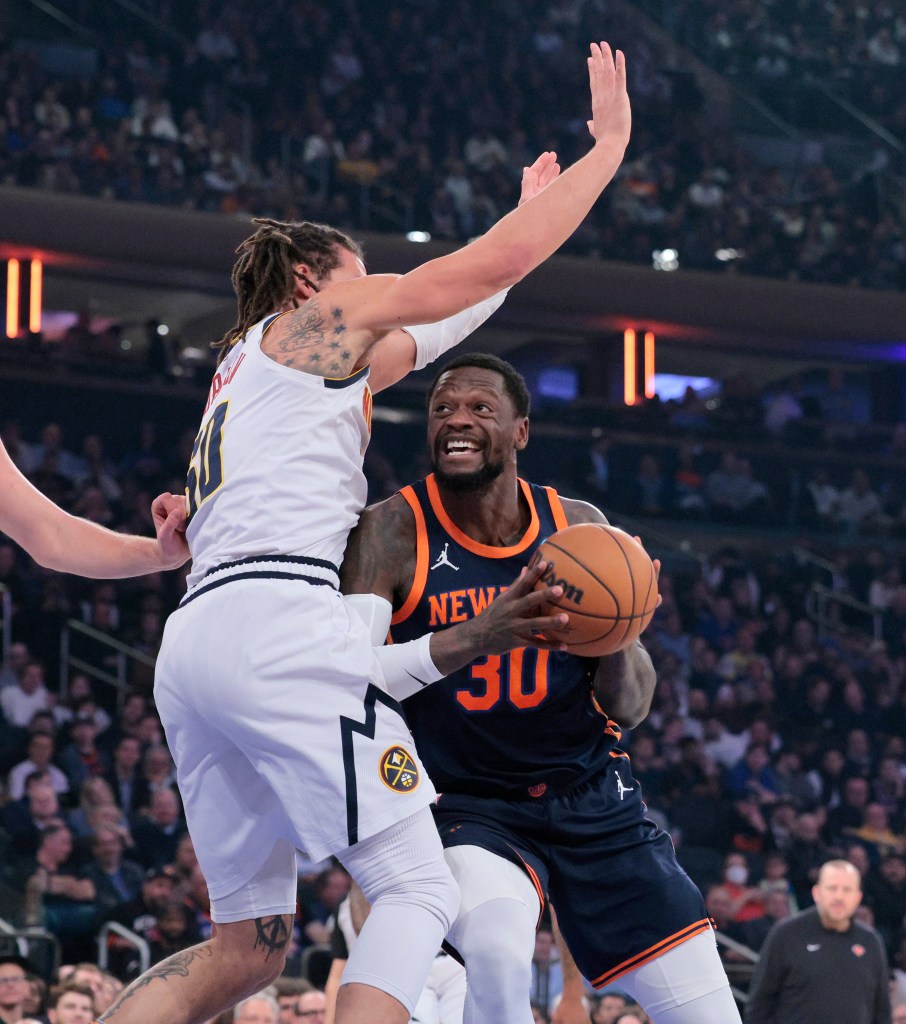 Knicks forward Julius Randle #30 drives to the basket as Denver Nuggets forward Aaron Gordon #50 defends during the first quarter.