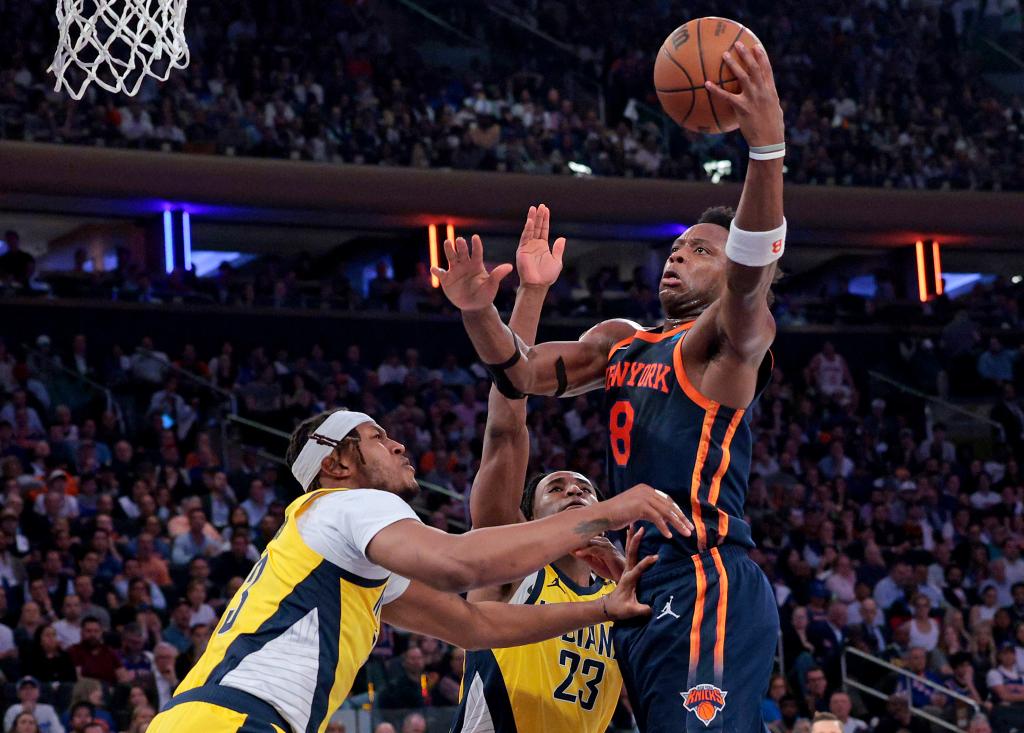 New York Knicks forward OG Anunoby shooting a basketball over Indiana Pacers' Myles Turner and Aaron Nesmith during the 2024 NBA Playoffs at Madison Square Garden