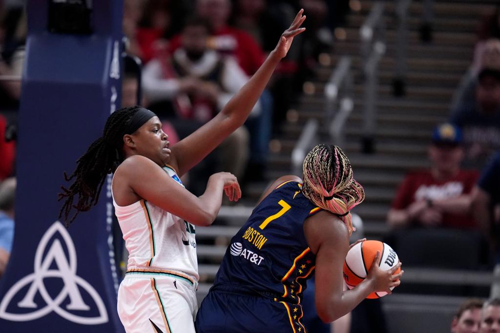 Jonquel Jones tries to block a shot by Indiana Fever forward Aliyah Boston (7) in the first half of a WNBA basketball game, Thursday, May 16.
