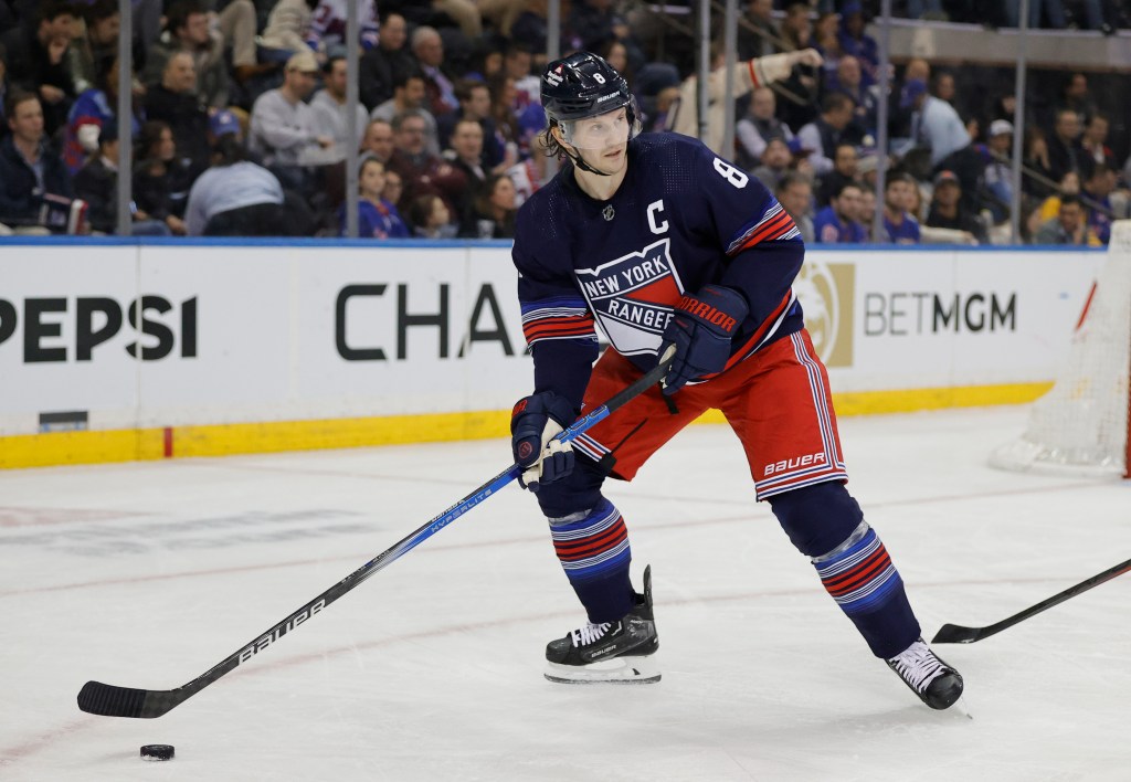 Rangers defenseman Jacob Trouba moves the puck down ice