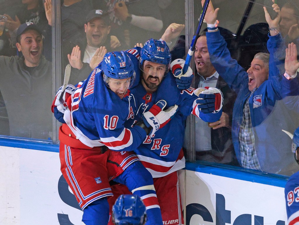 Rangers left wing Artemi Panarin #10 jumps on New York Rangers left wing Chris Kreider #20 as he celebrates after he scores a goal