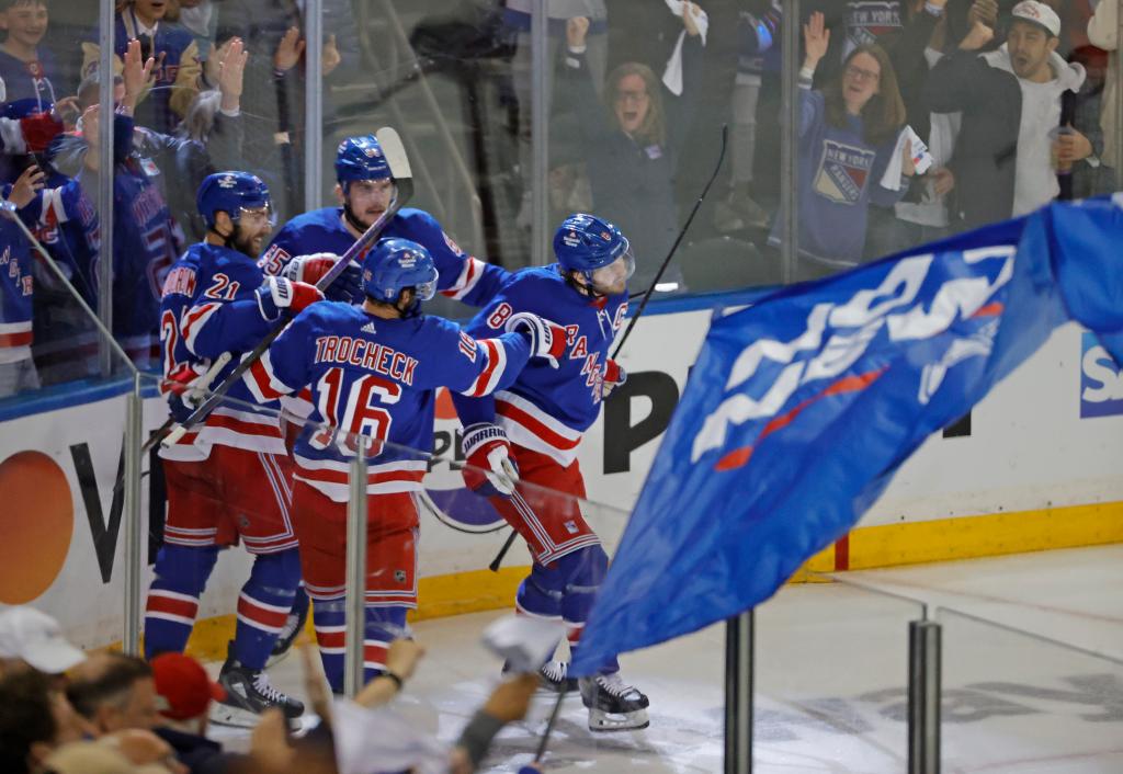 Rangers defenseman Jacob Trouba celebrates with his teammates after he scores a goa